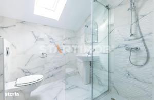 a bathroom with a shower and a toilet and a sink at Vila Dor de Munti in Râşnov +22 photos