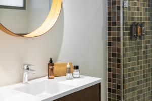 a bathroom with a sink and a mirror and a shower at Parker The Urban Flats in Valencia +73 photos