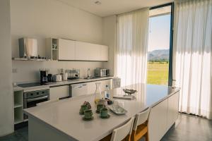 a kitchen with a white counter top and a large window at Casa Luoni Hotel Boutique & Aparts in San Luis