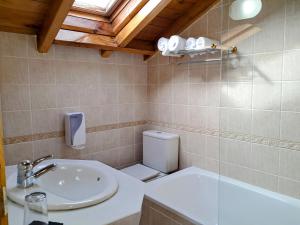 a bathroom with a sink and a toilet at Hotel San Roque in Reinosa +68 photos