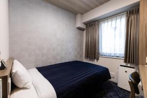 a hotel room with a bed and a window at Kyoto Plaza Hotel in Kyoto +26 photos