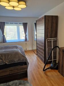 a bedroom with a bed and a large window at Wohnung in Neuss - nähe Düsseldorf in Neuss