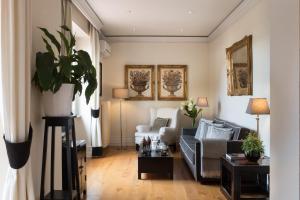 a living room with a couch and a table at Tornabuoni Suites Collection Residenza D'Epoca in Florence