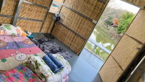 an overhead view of a bedroom with a bed and a window at Poopha home stay in Amphoe Pai