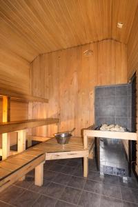 a sauna with wooden walls and a bowl on a table at Linnamehe Holiday Centre in Kuiaru