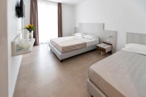 Postel nebo postele na pokoji v ubytování Vasto Aparthotel