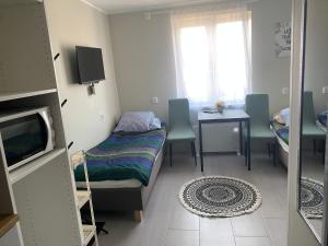 a small room with a bed and a table at Małe MIESZKANIE blisko PKP, PKS in Elblag
