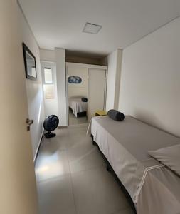 a small room with a bed and a room with a bedroom at 2 DTS - Bela Vista - espaçoso + aconchegante in Sao Paulo