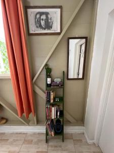 a stairway with a book shelf and a mirror at Adella's Blue Mountain Coffee Farmstay in Kingston