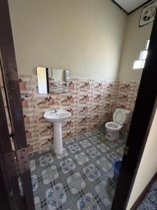 a bathroom with a sink and a toilet at Thavixai Guesthouse in Nongkhiaw