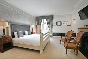 Postel nebo postele na pokoji v ubytování Stanton Manor Hotel