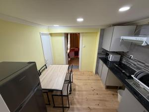 a small kitchen with a table and a table and chairs at Rossio Downtown in Lisbon
