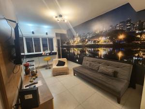 a living room with a large city mural on the wall at Bela Vista 74 - amplo + prático + confortável in São Paulo