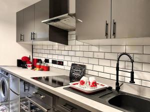 a kitchen with a sink and a counter top at Boutique Backyard Bungalow - Brimsdown in Enfield Lock