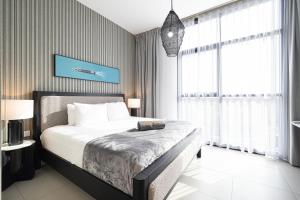 a bedroom with a bed and a large window at The Cloud 9 Penthouse by Blue Cloud Holidays in Sharjah Intl +56 photos