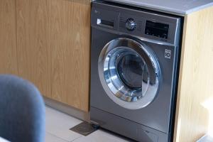 a washer and dryer sitting in a room at The Cloud 9 Penthouse by Blue Cloud Holidays in Sharjah Intl