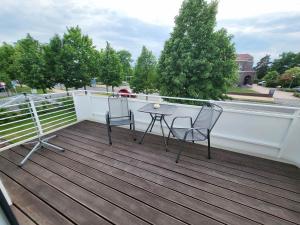 a patio with two chairs and a table on a deck at Fewo Exklusiv Seeblick in Großräschen +4 photos