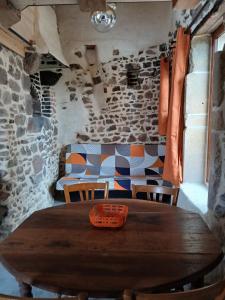 a wooden table with a basket on it in a room at gîte les 3 coquelicots bis in Coublanc +3 photos