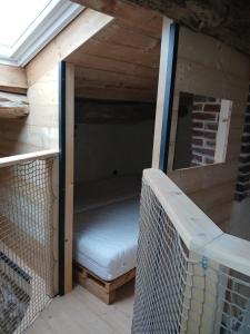 a inside of a chicken coop with a bed in it at gîte les 3 coquelicots bis in Coublanc