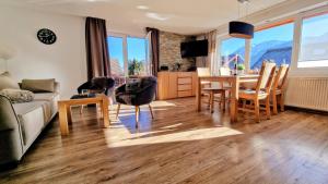 a living room with a couch and a table and chairs at Ferienwohnung in Pfronten +6 photos