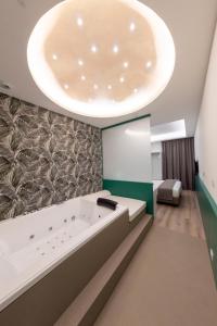 ナポリにあるSmart Hotel Napoliの大きな天井の客室で、大きなバスタブが備わります。