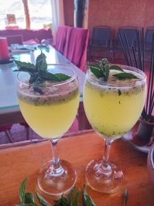 two cocktails sitting on top of a wooden table at Ecoturismo El Refugio en La Colorada, Combarbalá in Combarbalá +24 photos