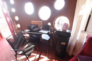 an office with a desk with a laptop and a chair at Ecoturismo El Refugio en La Colorada, Combarbalá in Combarbalá