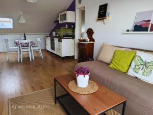a living room with a couch and a table at Apartments ALI & EL - perfect for couples in Rovinj