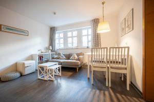 a living room with a table and a couch at Inselresidenz Strandburg 104 in Juist