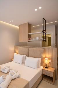 a bedroom with a large bed with white pillows at Urban Athens Gem in Athens