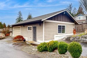 a small house with a driveway in front of it at The Cozy Nook in Bonney Lake