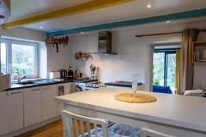 a kitchen with white cabinets and a counter top at Ty Grégoire - Campagne - Wi-Fi in Crozon