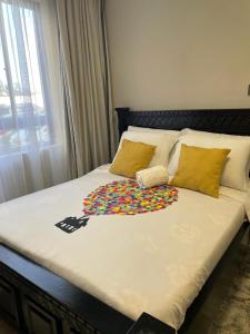 a large bed with a colorful blanket on it at Naji Homes in Athi River +18 photos