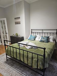 a bedroom with a bed with a metal frame at Homey flat in Perth