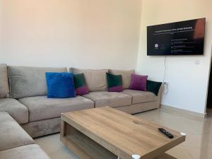 a living room with a couch and a coffee table at Spartel House 05 in Tangier