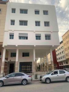 two cars parked in front of a building at Spartel House 05 in Tangier