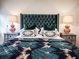 a bedroom with a large bed and two night stands at The Stag in Salhouse