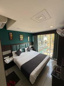 Ένα ή περισσότερα κρεβάτια σε δωμάτιο στο Hotel Sunview
