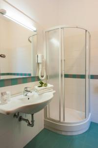 a bathroom with a sink and a shower at Hotel La Carruba in Cetraro