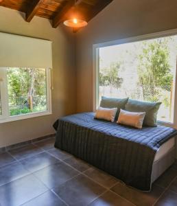 a bedroom with a bed and a large window at La Francisca in San Carlos de Bariloche