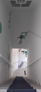 a staircase in a building with a painting on the wall at Sol do Pernambuco in Guarujá