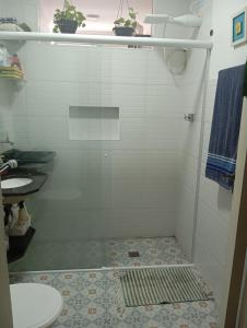 a bathroom with a shower with a toilet and a sink at Beira mar 2 in Santos +23 photos
