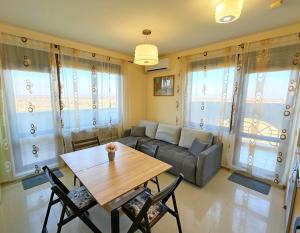 a living room with a couch and a table at Sunny Ap in Golf Complex Lighthouse in Balchik +18 photos