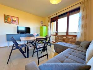 a living room with a couch and a table at Sunny Ap in Golf Complex Lighthouse in Balchik