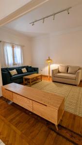 a living room with a couch and a coffee table at Mesaha I Madina Apt I 2min to Nile in Cairo