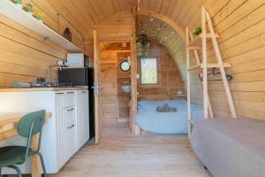 a bedroom with a bed in a wooden cabin at Casale Scirbia in Marzamemi