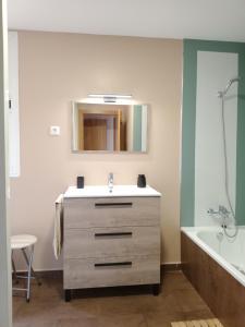a bathroom with a sink and a mirror and a tub at El Vergel del Piedra in Munébrega +28 photos