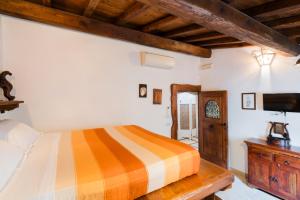a bedroom with a bed and a flat screen tv at Letto & Merenda in Nardò