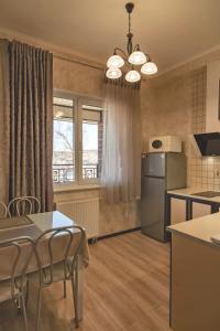 a kitchen with a table and chairs and a refrigerator at FAVAR Carpathians in Skhidnitsa +26 photos