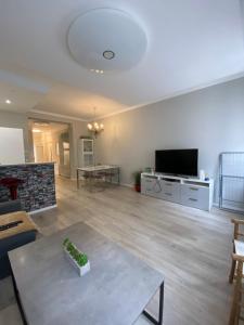 a living room with a table and a tv at Apáczai Apartment nearby Chain Bridge in Budapest